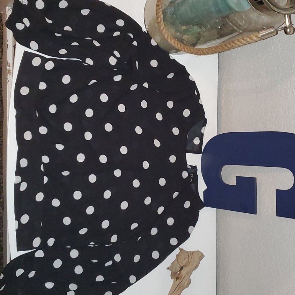 A black and white polka dot cropped formal shirt.